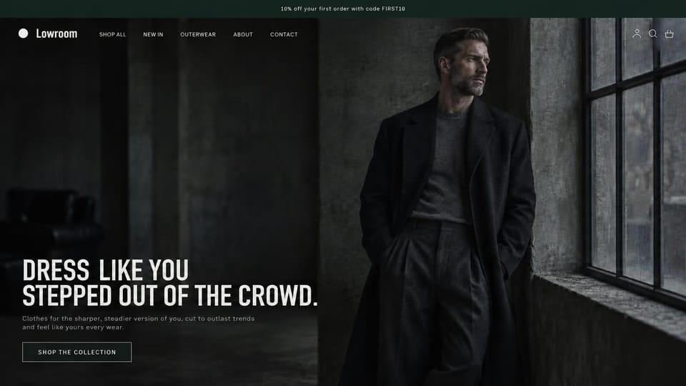 Fashion website design, moody menswear in a dark industrial loft: near-black top bar, a dark loft photo of a gray-bearded man in a long black coat and charcoal knit by a tall steel window, a round white logo mark, a large white condensed headline and an outlined button