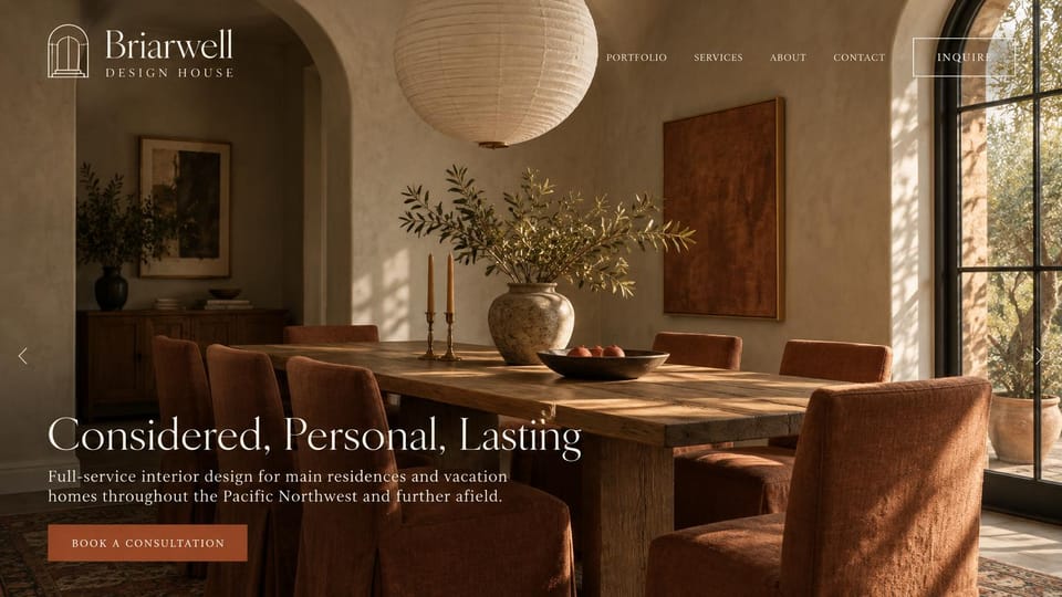 Interior design website design, main and vacation homes in rust and plaster: a plaster dining room with rust slipcovered chairs, a cream serif headline and a rust consultation button