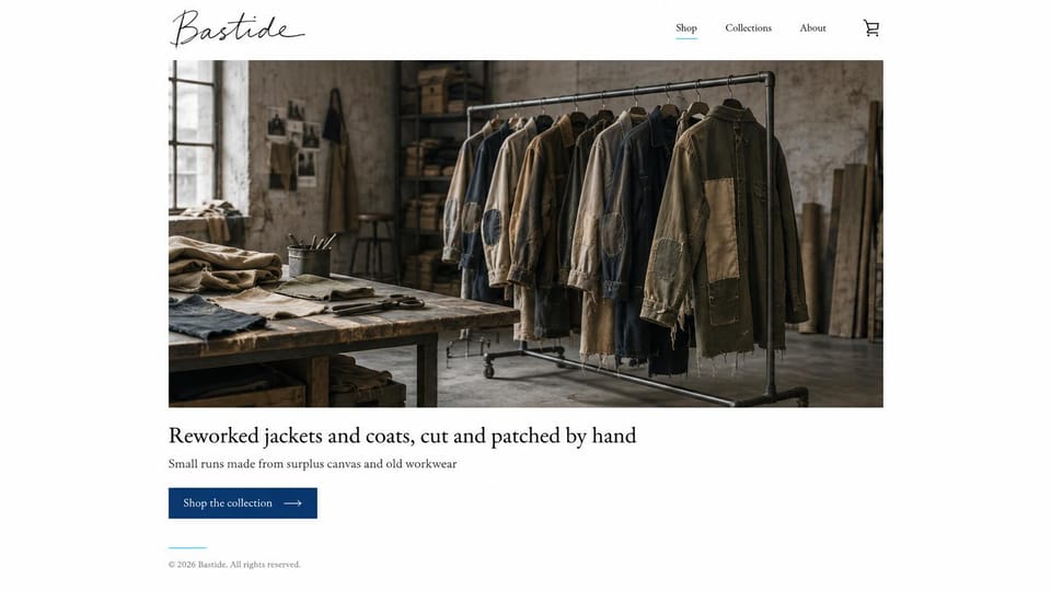 Fashion website design, reworked jackets on a workshop rail: white page with a script logo, a contained photo of patched jackets on a rail in a workshop, a dark serif headline and a navy button