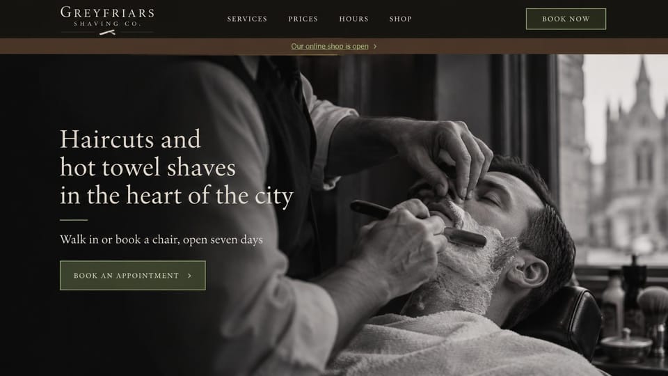 Barbershop website design, straight-razor shaves with an online shop bar: near-black header, a brown bar announcing an online shop, a sepia photo of a straight-razor shave by a window with a church spire, a light serif headline and an olive button
