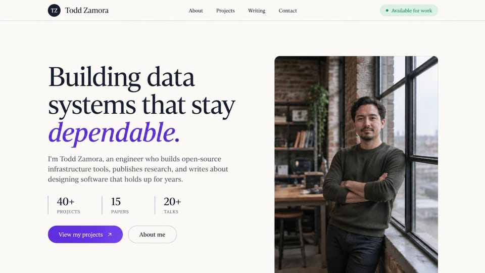 Developer portfolio website design, infrastructure engineer, available for work: cream page, a navy serif headline ending in violet italics beside a portrait of a man at a loft window