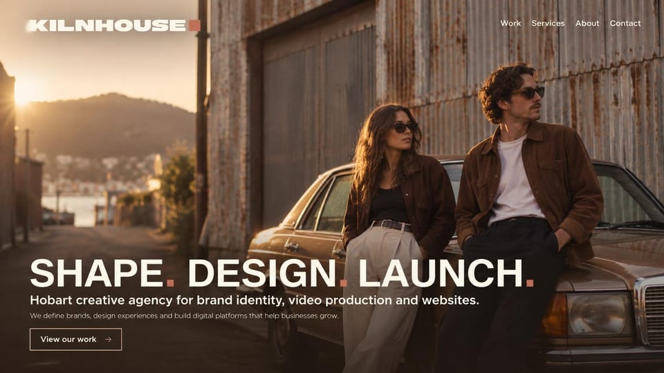 Agency website design, regional creative agency at golden hour: a couple by an old car against a rusty shed at sunset, a large white headline with red periods