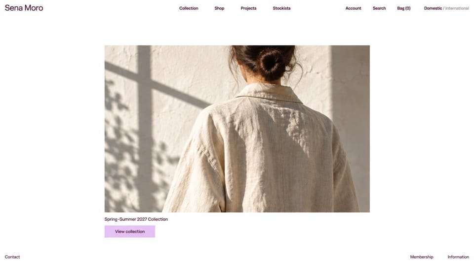 Fashion website design, designer label with a small centered photo: white page, a small centered photo of a woman's back in a linen jacket with window shadows, a serif headline and a lilac button