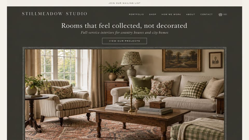 Interior design website design, country houses framed in charcoal: charcoal page with a centered cream serif headline and outlined button above a framed English living room in florals and checks