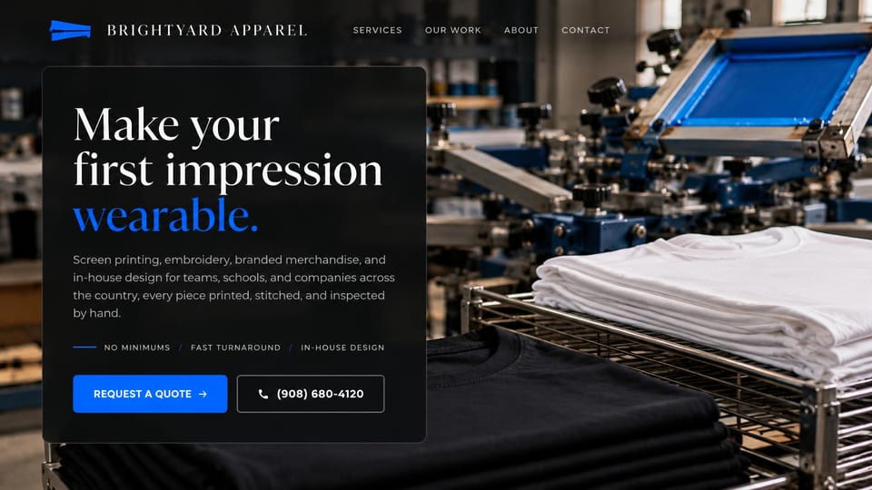 Printing website design, screen printing and embroidery, dark and refined: near-black page, a white and blue serif headline in a dark panel over a screen printing press and stacks of folded shirts, a blue quote button