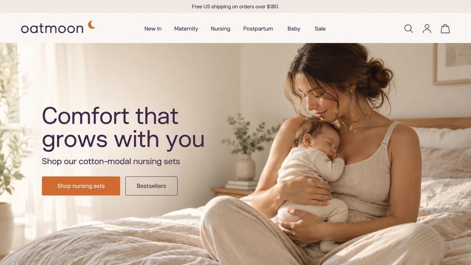 Fashion website design, nursing sets with a mother and newborn in bed: cream header with a lowercase logo and orange moon, a sunlit bedroom with a mother in an oatmeal ribbed tank cradling a sleeping newborn, a large plum headline, an orange button and an outlined button