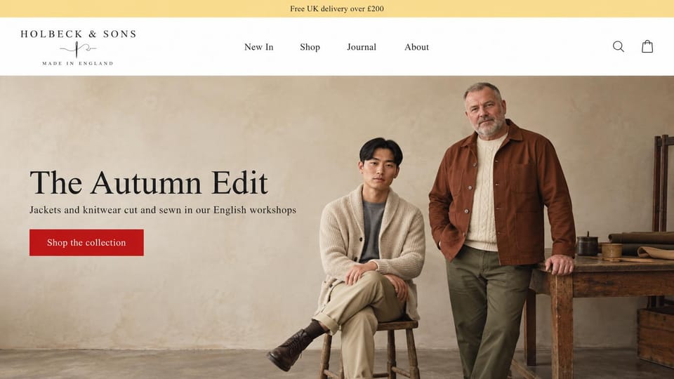 Fashion website design, heritage menswear for young and older men: white header with a needle-and-thread logo, a plaster studio with a young man in a cream cardigan on a stool and an older man in a rust chore jacket by a workbench, a black serif headline and a red button