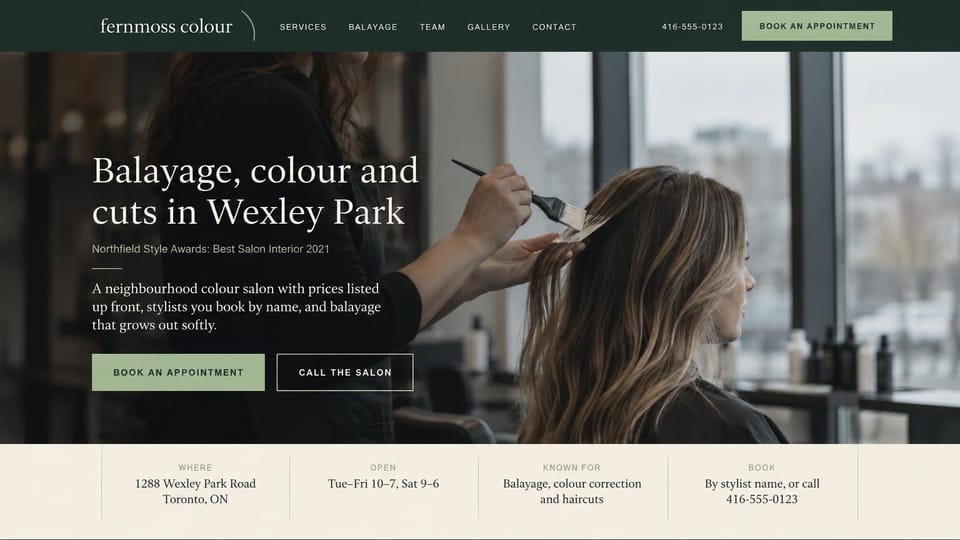Business website design, balayage salon with the basics in a strip below: dark green menu bar, a colorist painting balayage on a client by a window, white serif headline, sage and outlined buttons, a cream details strip below
