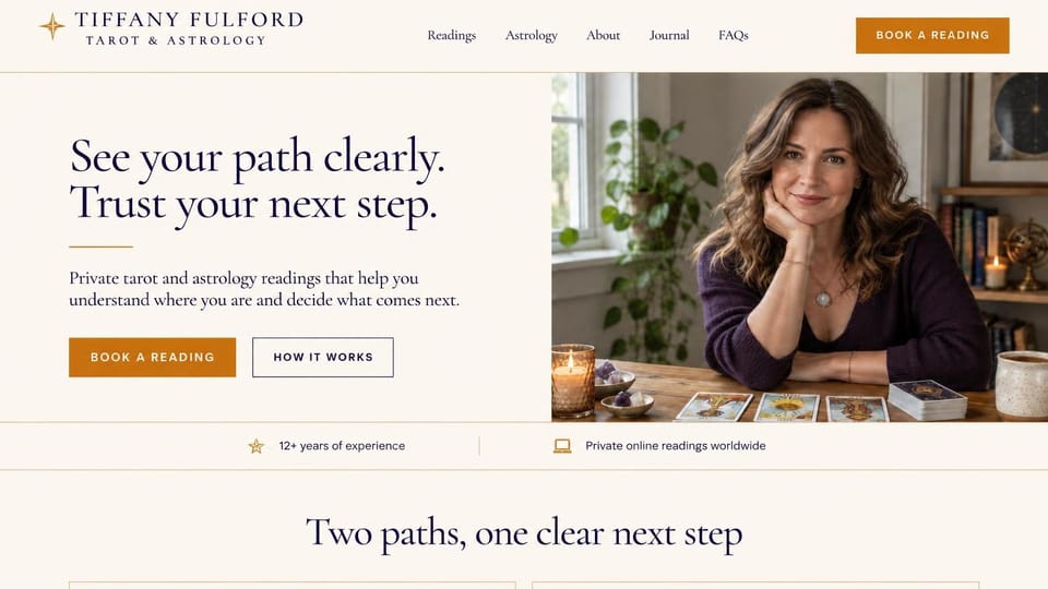 Astrology website design, online tarot and astrology with a how-it-works button: cream page, a navy serif headline, a copper button and an outlined how it works button beside a smiling reader at a table of tarot cards, a slim bar below