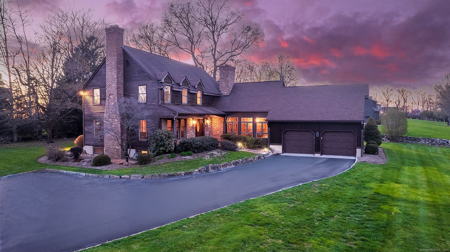 Brick and shingle colonial at sunset at 70 Davenport Farm Lane East