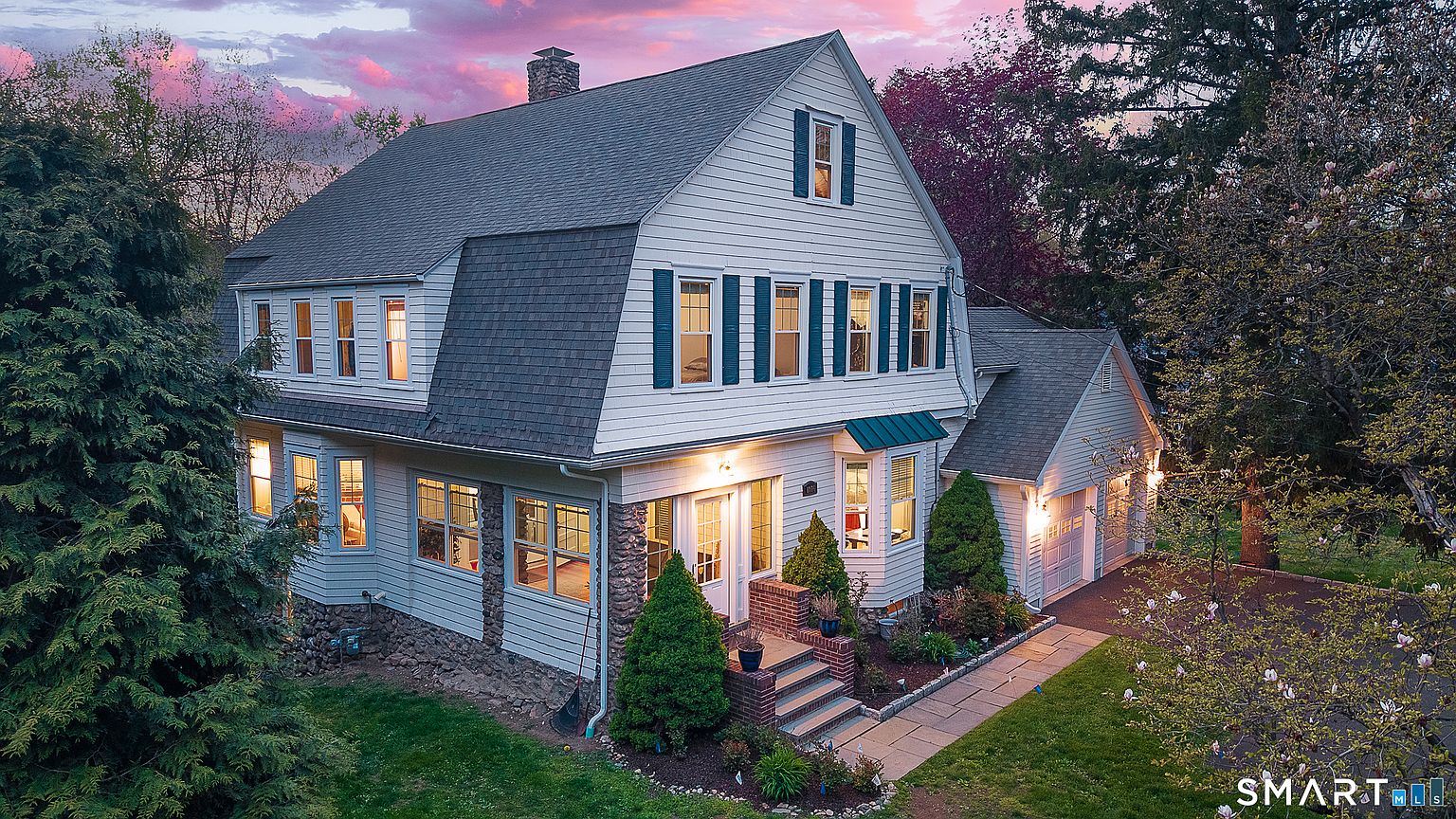 Gambrel home glowing at twilight at 1376 Hope Street