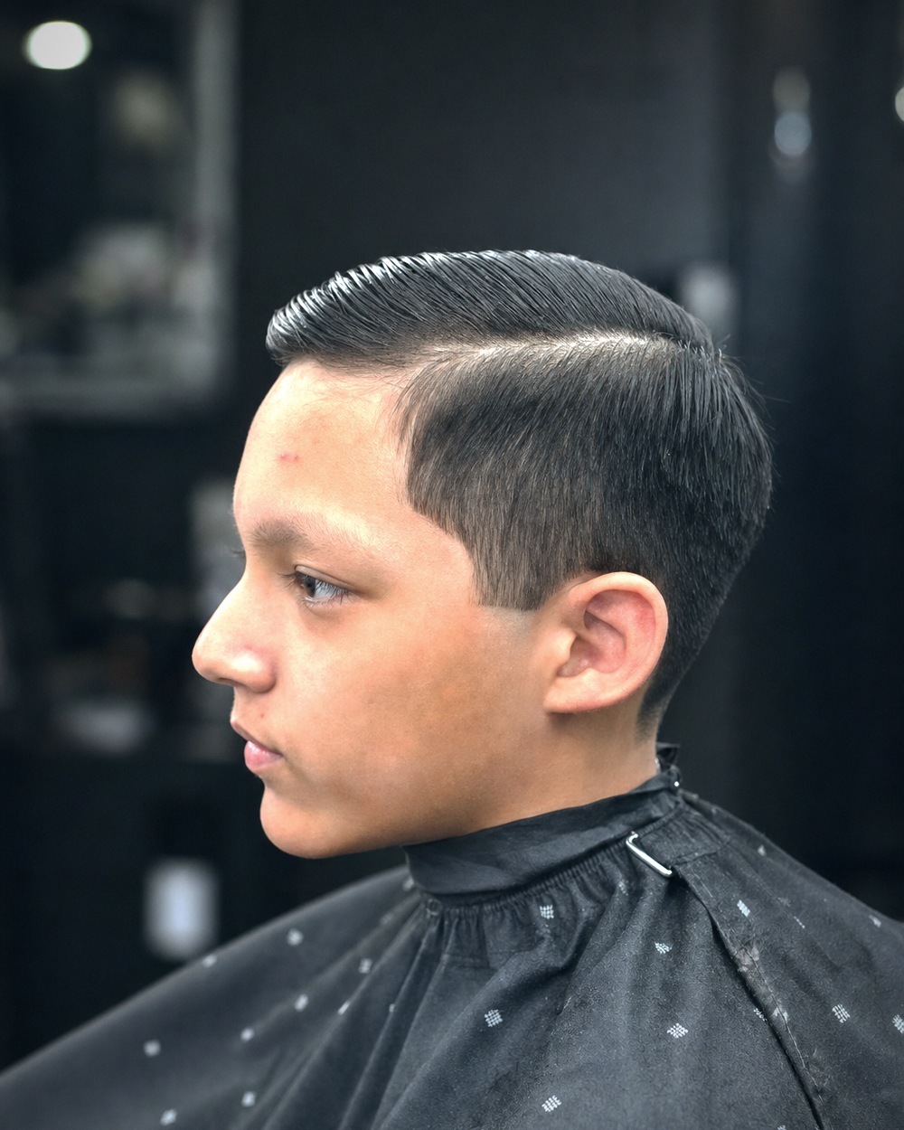 Kids side part combed clean after a fade